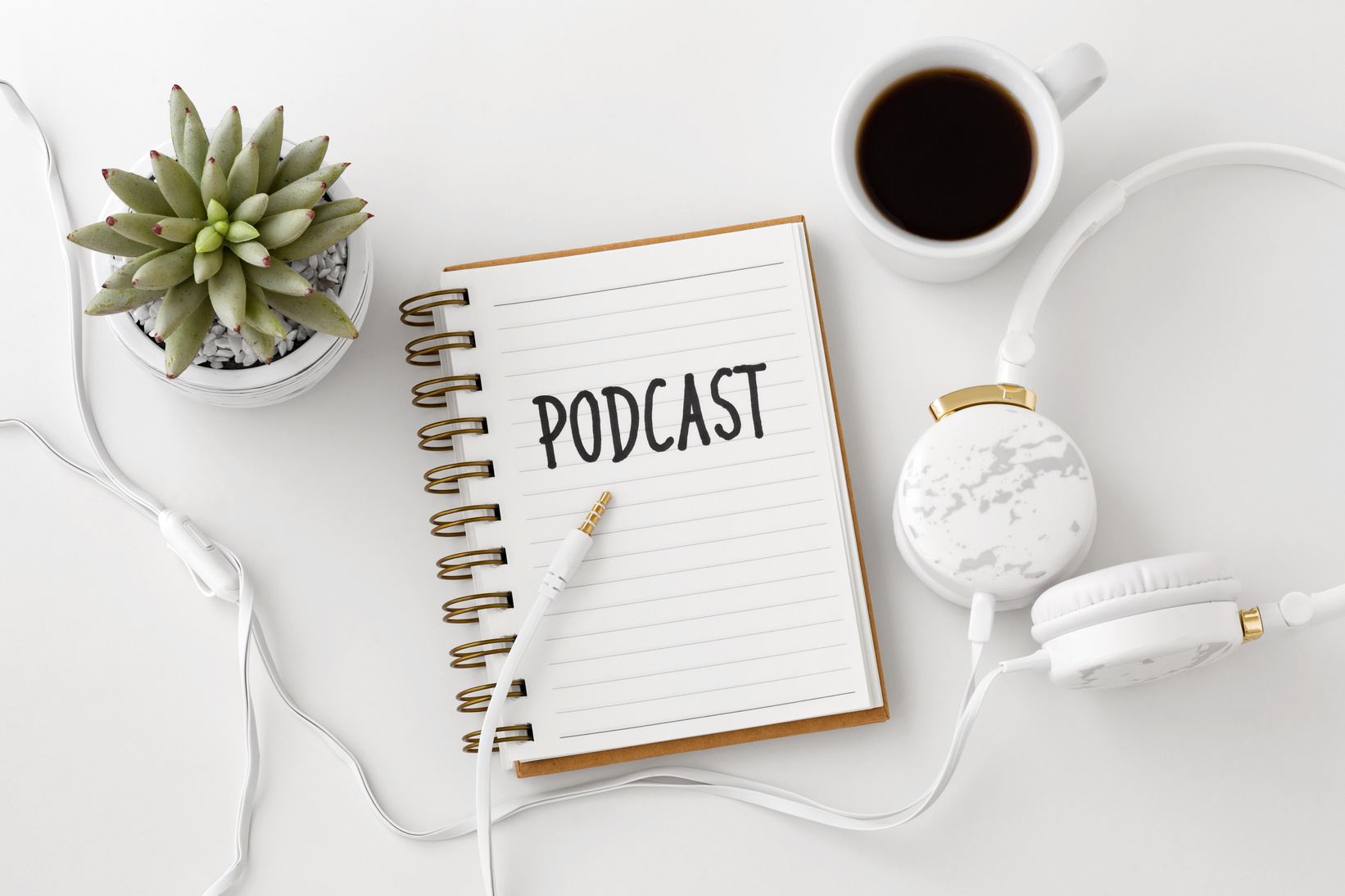 Podcast concept with headphones and notebook